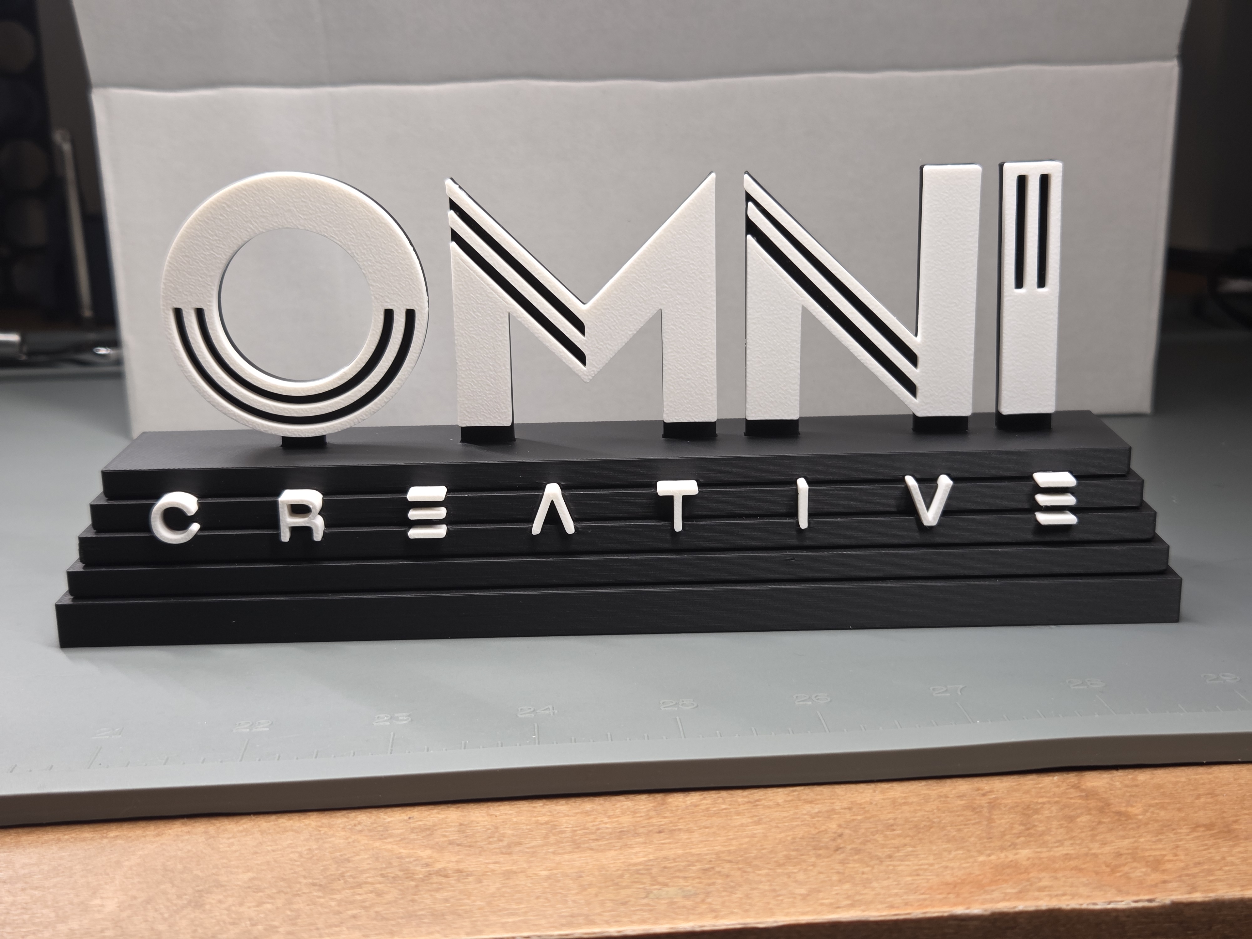 OMNI Creative two-tone logo display piece designed and printed in-house